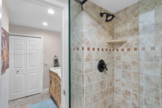 bathroom with vanity and tiled shower