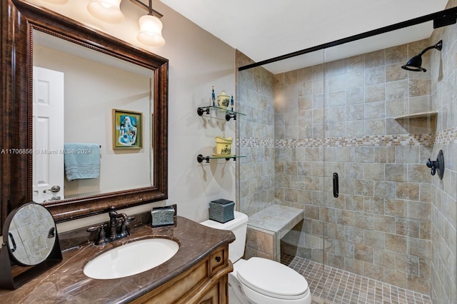 bathroom with vanity, toilet, and an enclosed shower