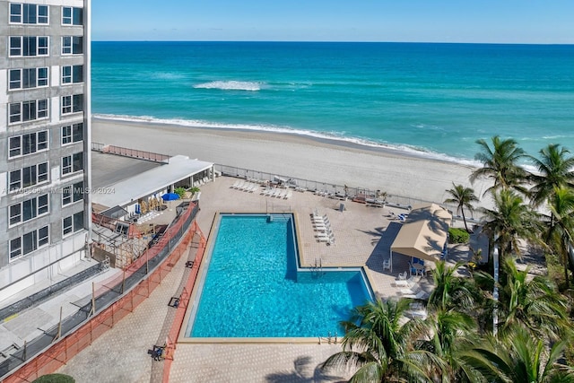 birds eye view of property featuring a view of the beach and a water view