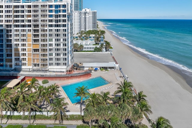 drone / aerial view featuring a water view and a view of the beach