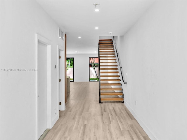 corridor with light wood-type flooring