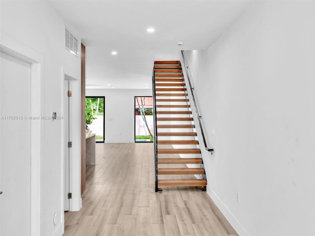 staircase with wood-type flooring