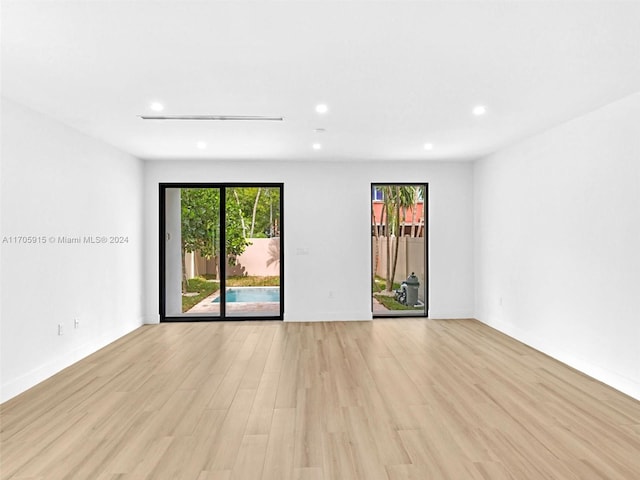 spare room featuring light hardwood / wood-style floors