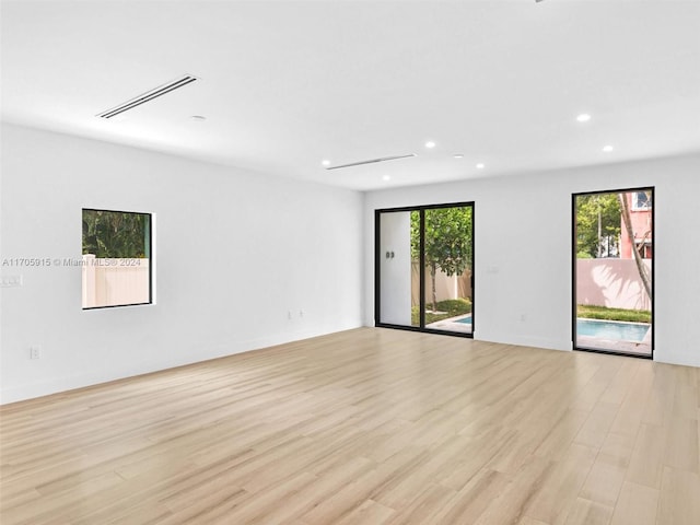 unfurnished room featuring light hardwood / wood-style floors