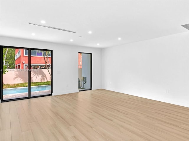 spare room featuring light wood-type flooring