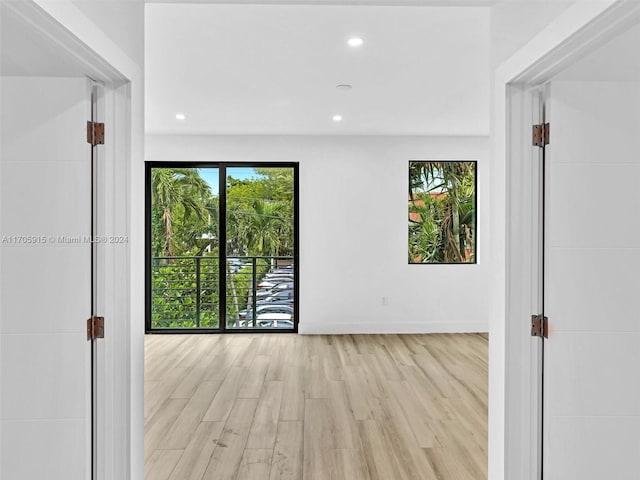 spare room with light hardwood / wood-style flooring