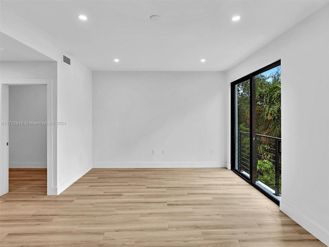 unfurnished room with light wood-type flooring