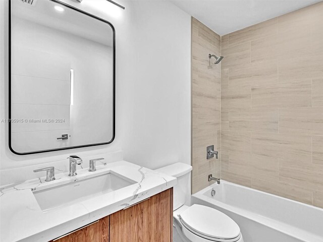 full bathroom with vanity, toilet, and tiled shower / bath