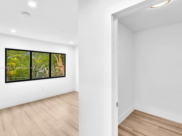 unfurnished room with light wood-type flooring