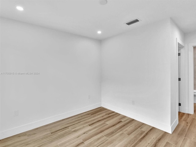 unfurnished room with light hardwood / wood-style flooring