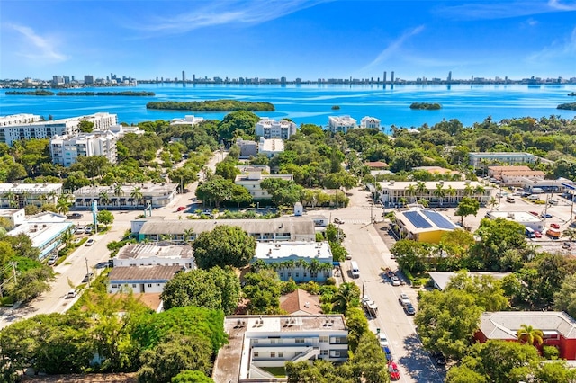 drone / aerial view featuring a view of city and a water view