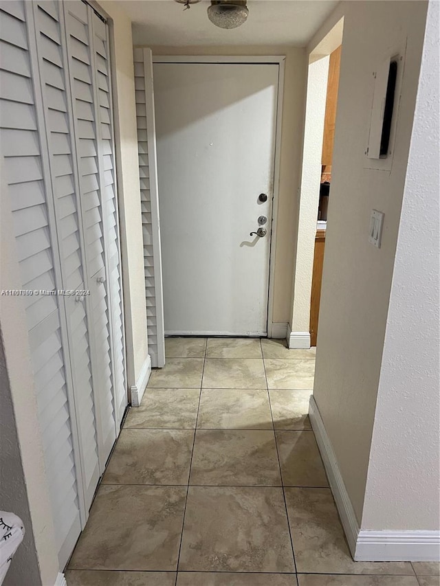 hall featuring light tile patterned floors