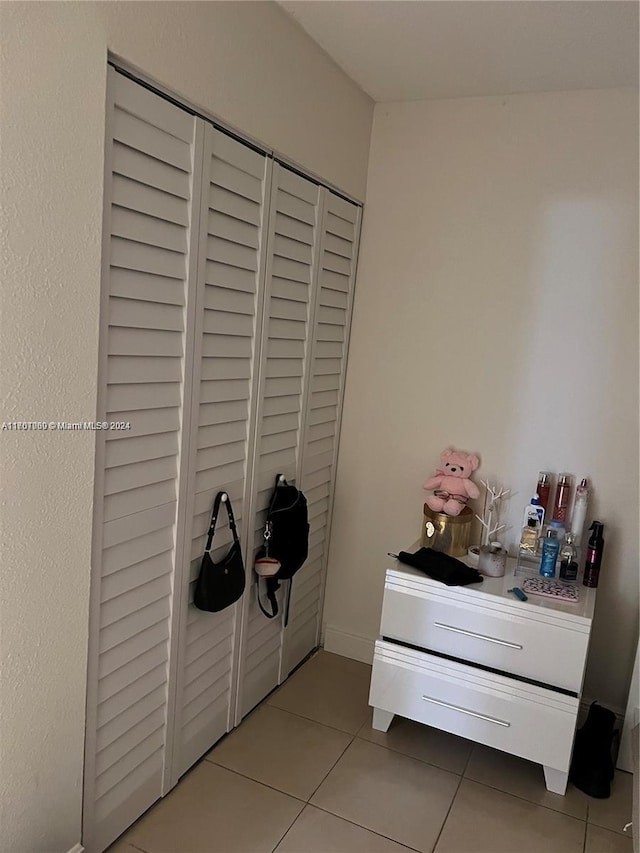 tiled bedroom featuring a closet