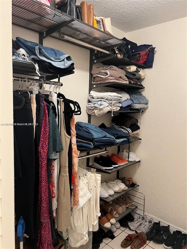 spacious closet featuring tile patterned flooring