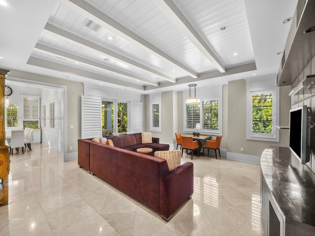 living room with beamed ceiling, a raised ceiling, wood ceiling, and french doors