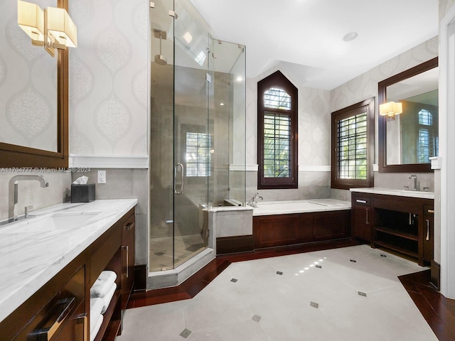 bathroom featuring tile patterned floors, vanity, and shower with separate bathtub