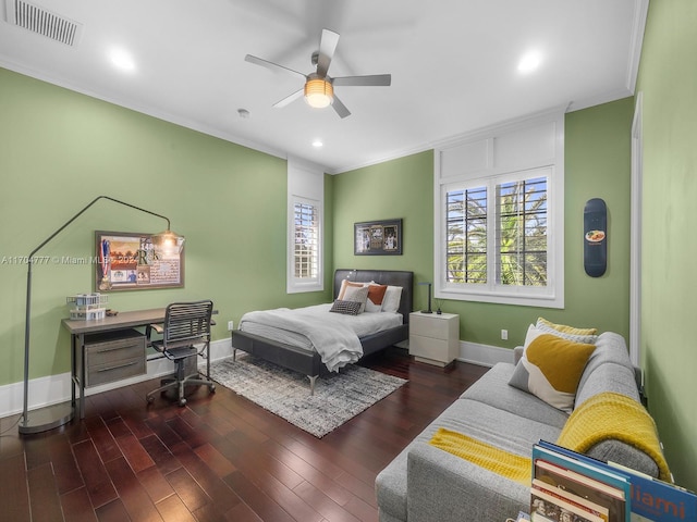 bedroom with ceiling fan, dark hardwood / wood-style flooring, and ornamental molding