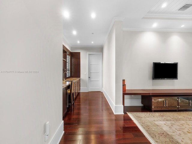 hallway with sink, dark hardwood / wood-style flooring, and crown molding