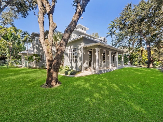 view of home's exterior featuring a porch and a lawn