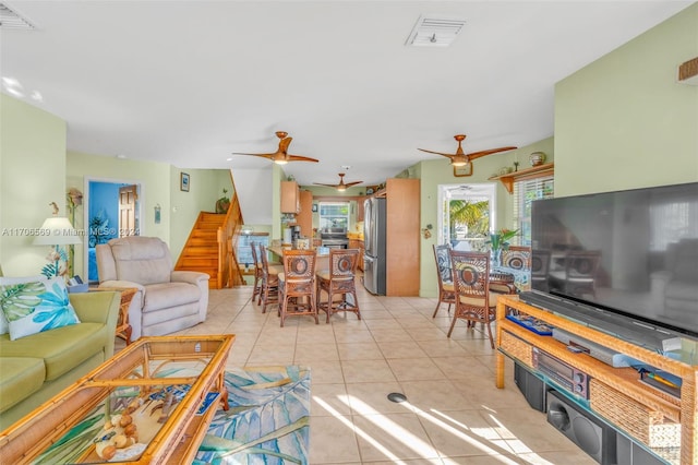 tiled living room with ceiling fan