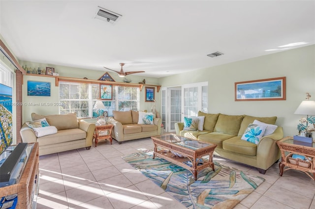 tiled living room with ceiling fan