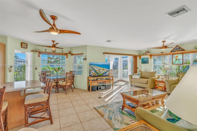 tiled living room with ceiling fan