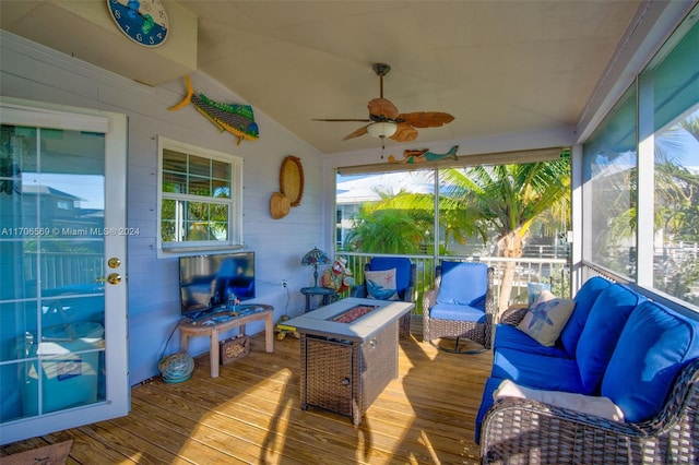 sunroom / solarium with ceiling fan and lofted ceiling