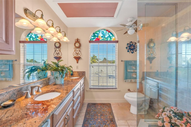 bathroom featuring ceiling fan, tile patterned flooring, an enclosed shower, toilet, and vanity