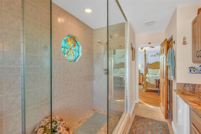 bathroom featuring vanity, a tile shower, and wood-type flooring