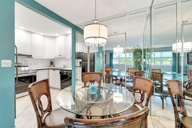 dining area featuring sink and a notable chandelier