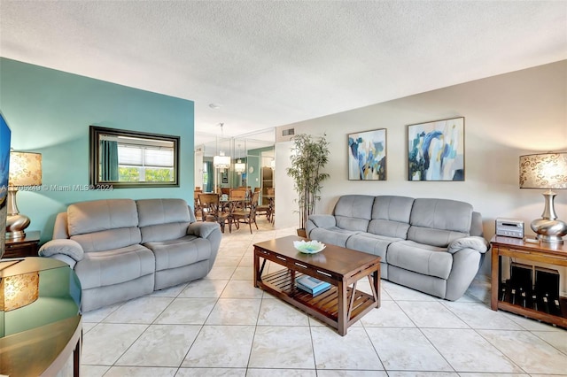 living room with light tile patterned floors and a textured ceiling