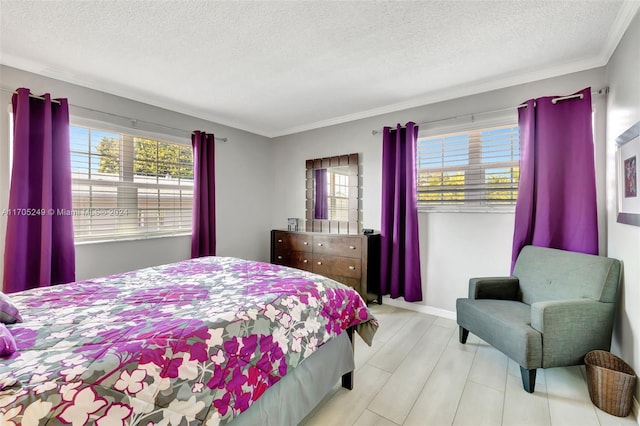 bedroom featuring a textured ceiling and ornamental molding