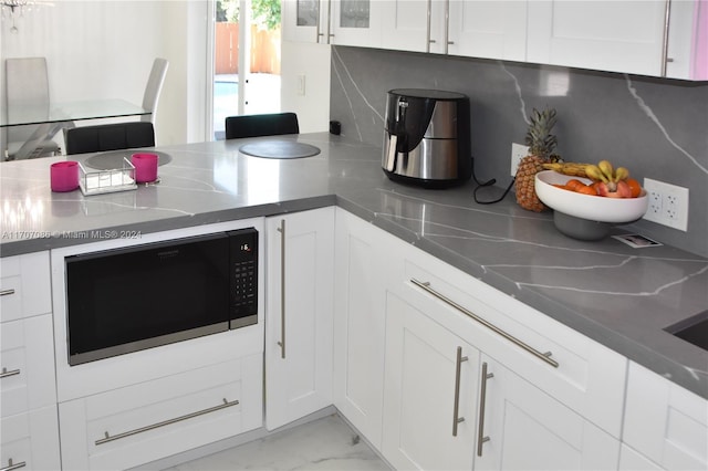 kitchen featuring white cabinets and decorative backsplash