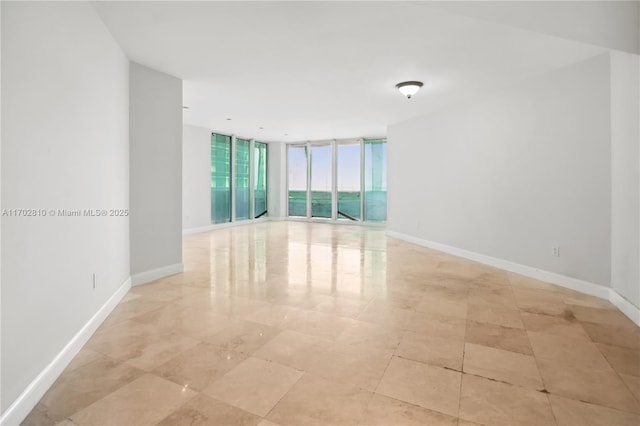 unfurnished room with expansive windows