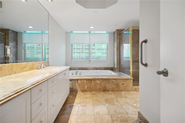 bathroom featuring vanity and plus walk in shower