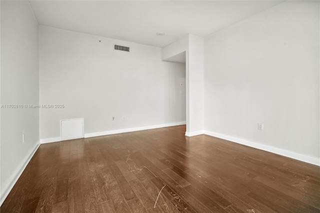 spare room with dark hardwood / wood-style flooring