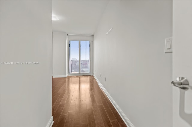 hall with hardwood / wood-style flooring