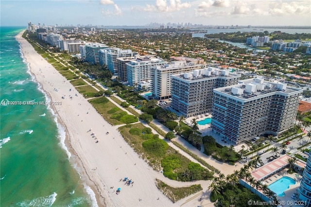 birds eye view of property with a water view and a view of the beach