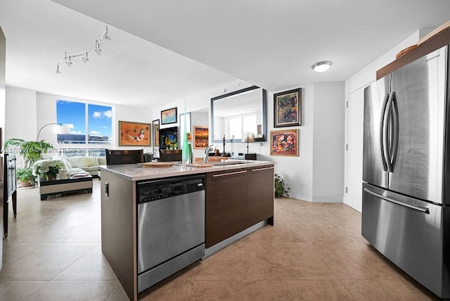 kitchen featuring plenty of natural light, a center island, sink, and stainless steel appliances