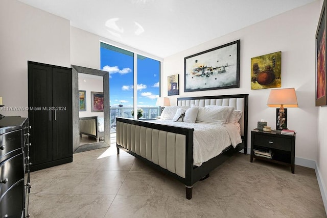 bedroom featuring floor to ceiling windows