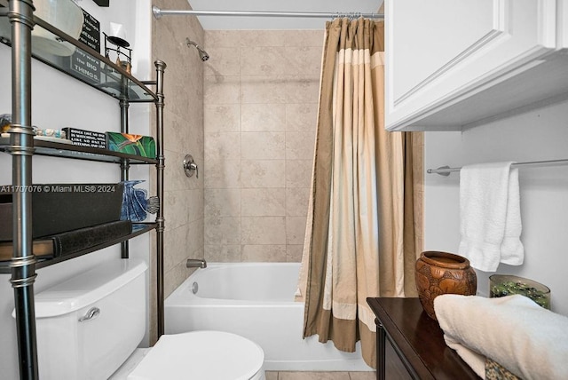 bathroom featuring tile patterned flooring, shower / tub combo, and toilet