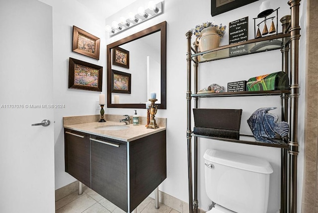 bathroom with tile patterned floors, vanity, and toilet