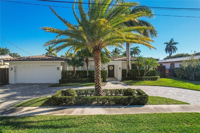 mediterranean / spanish-style house with a garage and a front yard