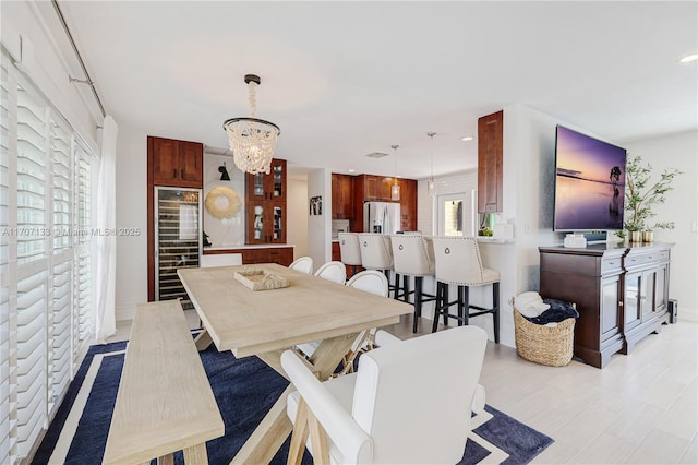 dining area featuring a chandelier and wine cooler