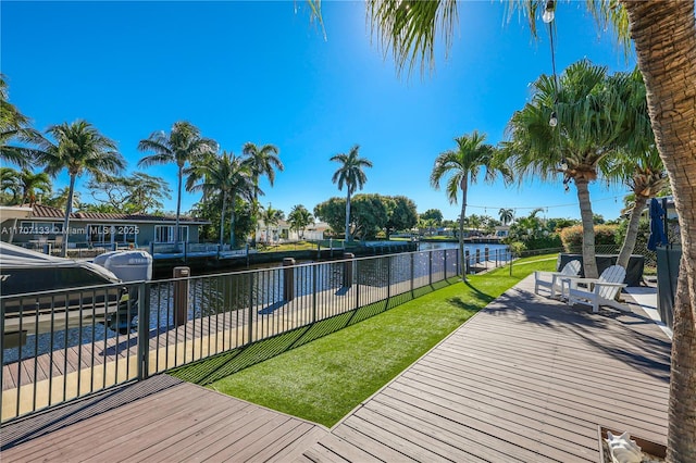 exterior space with a water view and a lawn