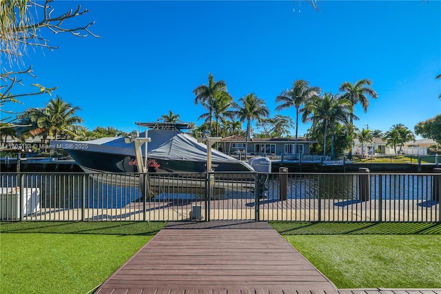 view of dock featuring a water view and a lawn