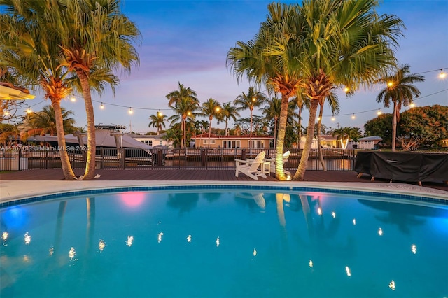 view of pool at dusk