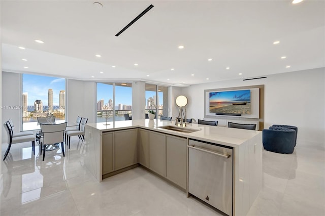 kitchen with stainless steel dishwasher, a center island with sink, sink, and a wealth of natural light