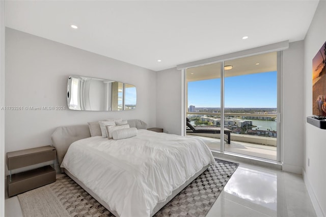 bedroom featuring access to outside and a water view