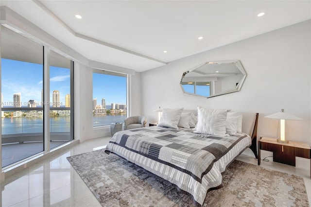 bedroom featuring light tile patterned flooring, access to outside, and a water view